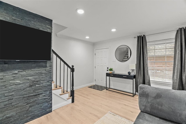 entrance foyer with wood-type flooring and ornamental molding