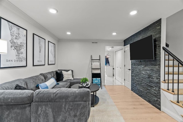 living room with light hardwood / wood-style floors and ornamental molding