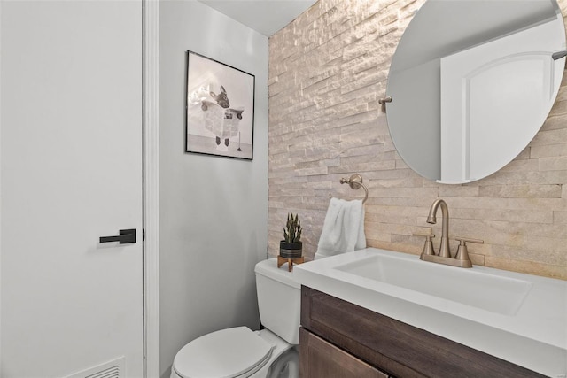 bathroom featuring backsplash, vanity, and toilet