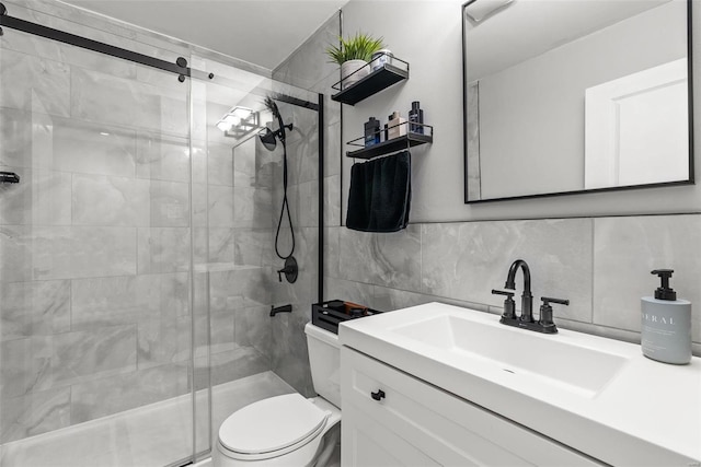 bathroom with vanity, a shower with door, toilet, tile walls, and tasteful backsplash