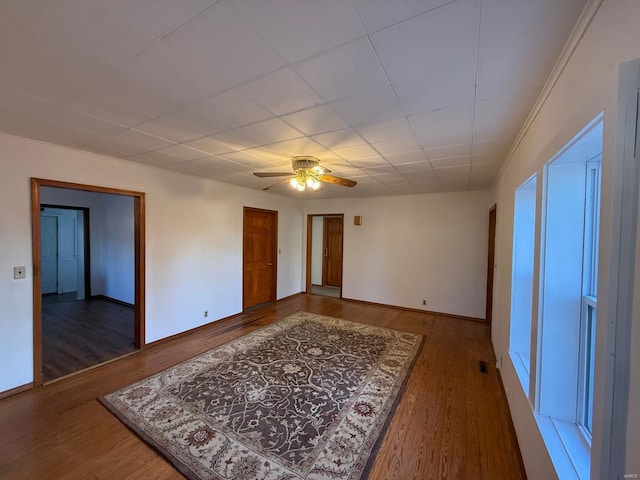 empty room featuring ceiling fan and dark wood-type flooring