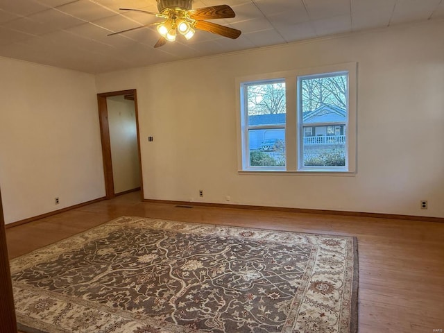 unfurnished room featuring hardwood / wood-style floors, ceiling fan, and ornamental molding