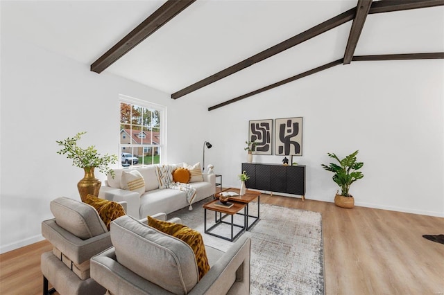 living room featuring light hardwood / wood-style flooring, radiator heating unit, and lofted ceiling with beams