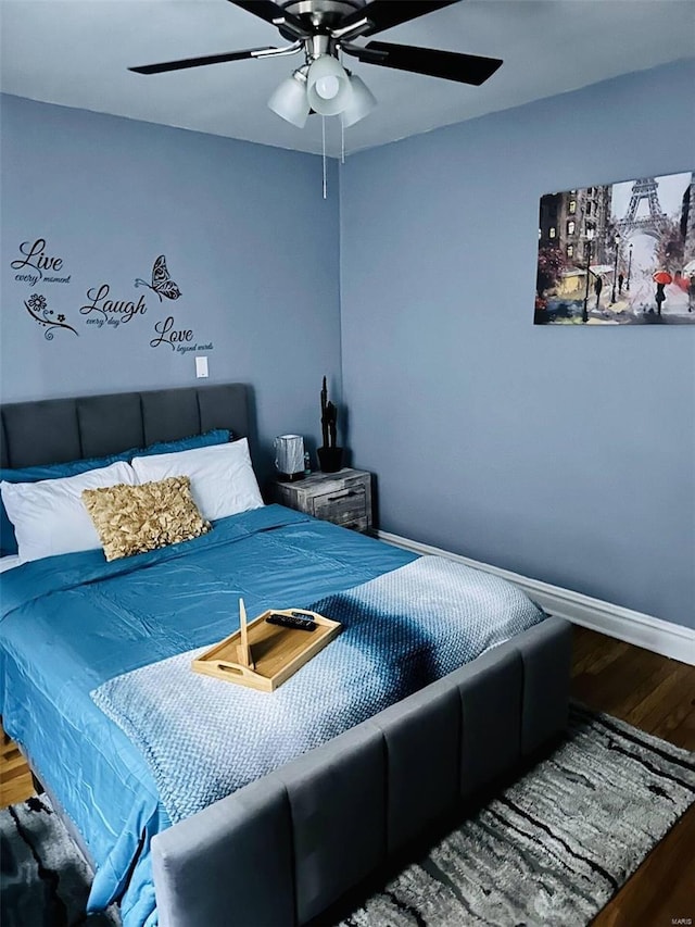 bedroom with hardwood / wood-style flooring and ceiling fan