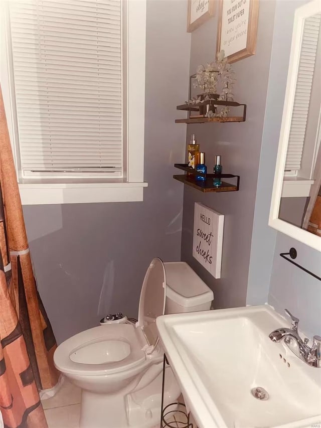 bathroom with tile patterned floors, sink, and toilet