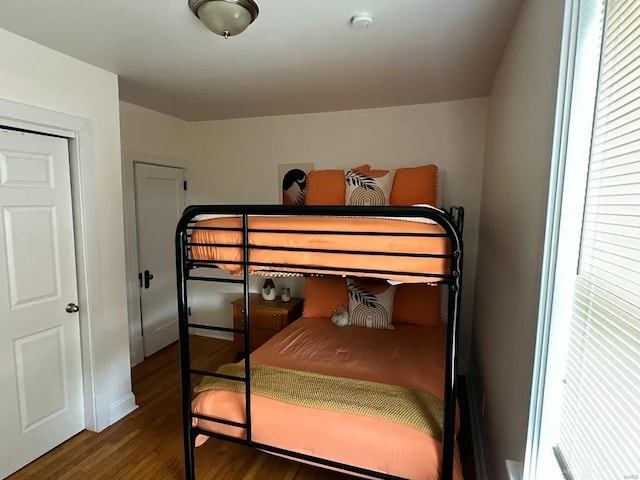 bedroom with dark wood-type flooring