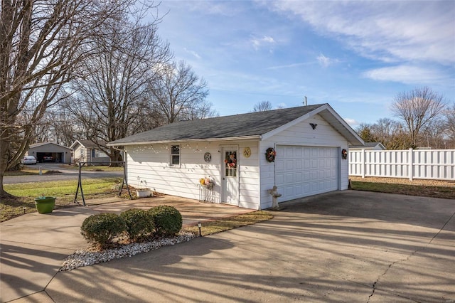 single story home with a garage and an outdoor structure