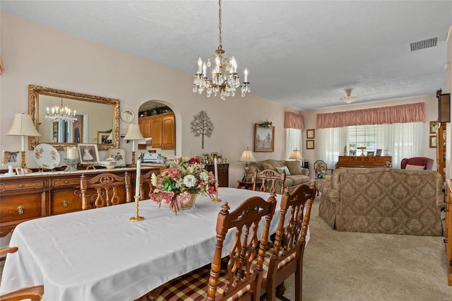 dining room with light carpet and a textured ceiling