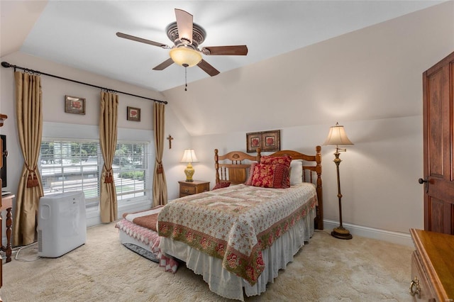 bedroom with ceiling fan, light carpet, and vaulted ceiling