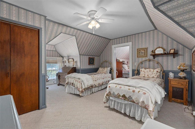 bedroom with ceiling fan, a closet, and light carpet