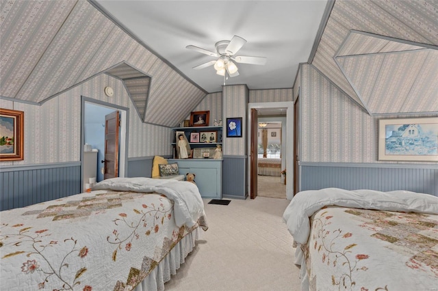 bedroom featuring connected bathroom, light colored carpet, and ceiling fan