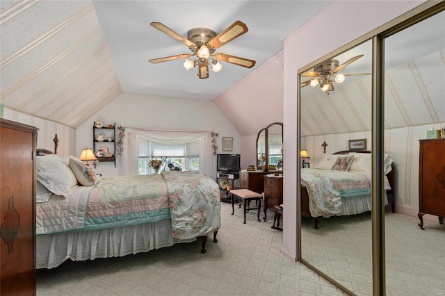 bedroom featuring light colored carpet, vaulted ceiling, and ceiling fan