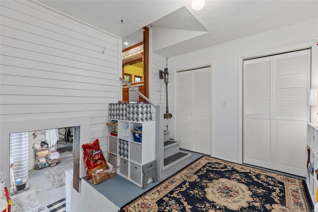 foyer entrance featuring wood walls