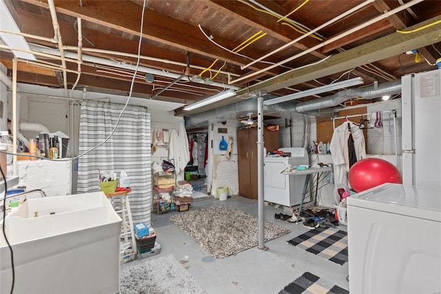 basement with separate washer and dryer and sink