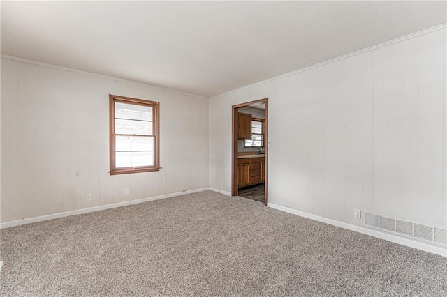 carpeted spare room with crown molding