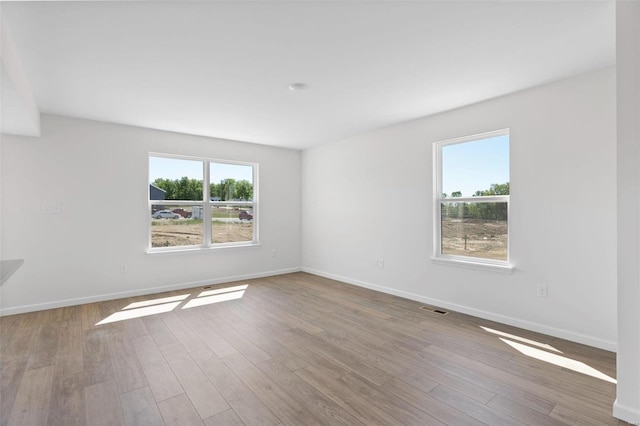 empty room with hardwood / wood-style flooring