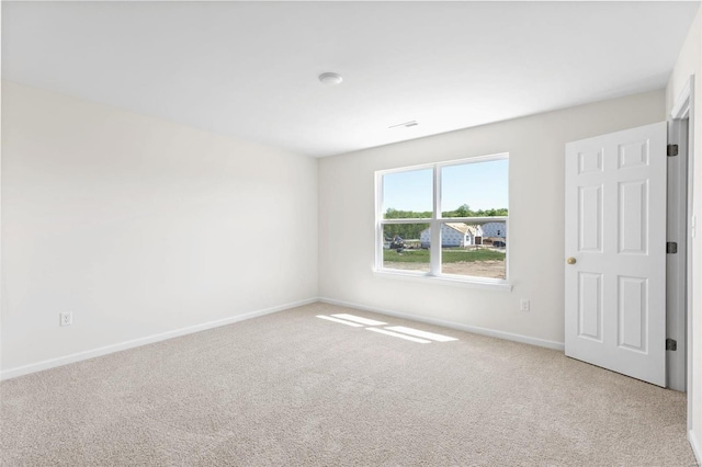 unfurnished room featuring light colored carpet