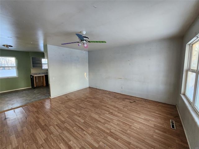 spare room featuring ceiling fan and hardwood / wood-style flooring