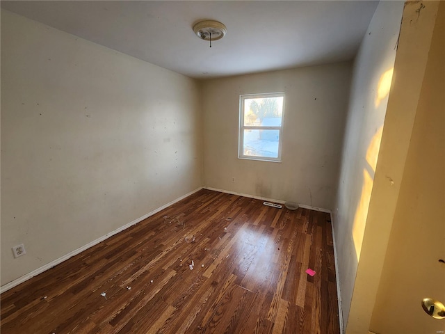 unfurnished room with dark hardwood / wood-style floors