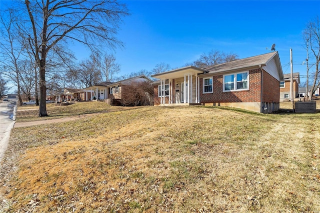 single story home featuring brick siding and a front lawn