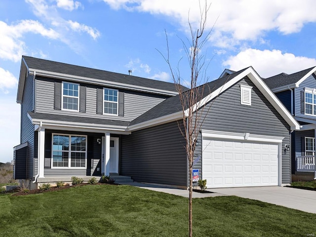 view of front of house featuring a front yard and a garage