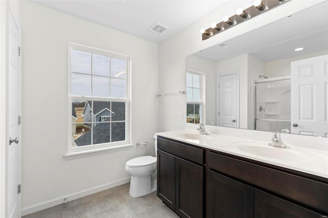 bathroom with vanity, toilet, and an enclosed shower