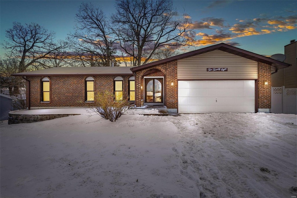 ranch-style home featuring a garage