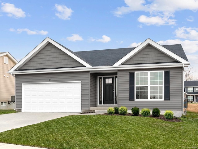 view of front of house with a front yard and a garage