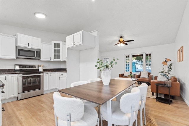 dining area with ceiling fan and light hardwood / wood-style floors