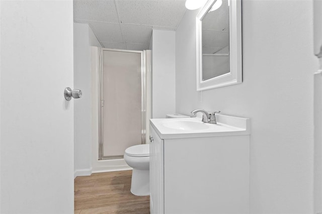 bathroom with a shower with shower door, vanity, toilet, and hardwood / wood-style floors