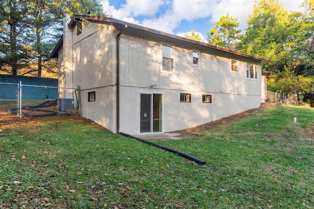 rear view of house featuring a lawn