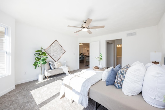 bedroom featuring carpet floors, ensuite bathroom, and ceiling fan