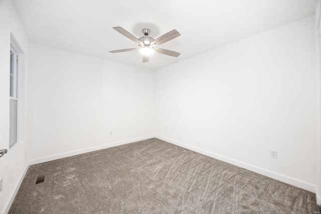 unfurnished room featuring ceiling fan and carpet floors