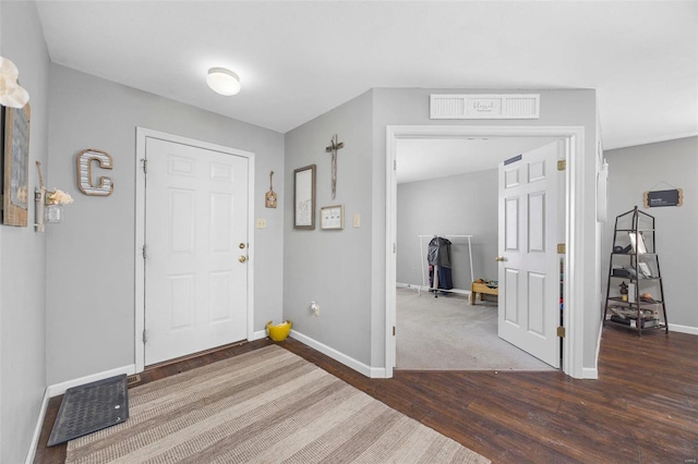 foyer entrance featuring dark wood-type flooring