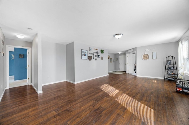 unfurnished living room with dark wood-type flooring