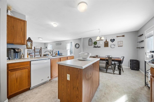 kitchen featuring white dishwasher, plenty of natural light, a center island, and pendant lighting