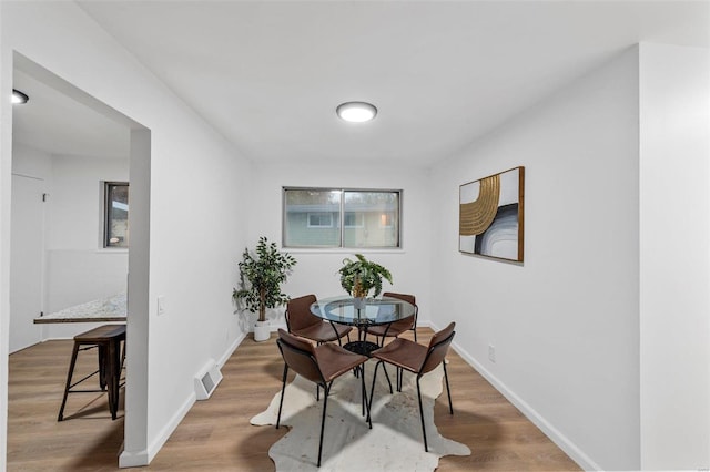 dining space featuring hardwood / wood-style flooring