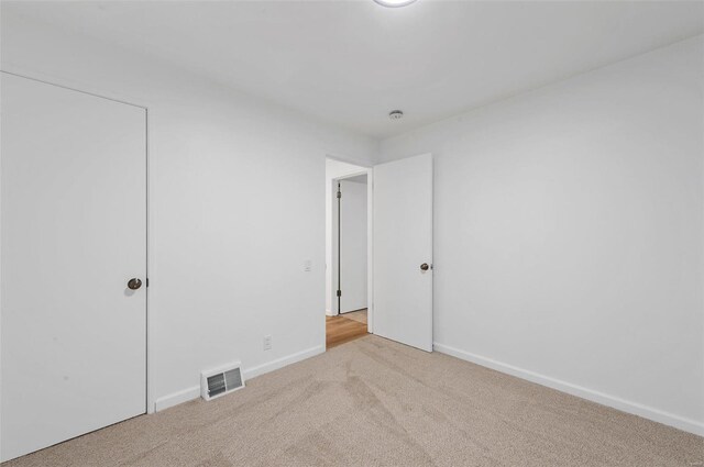 unfurnished bedroom with light colored carpet