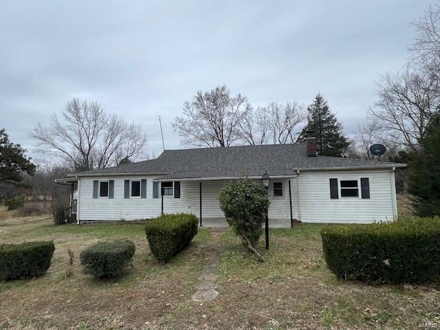 ranch-style home with a front lawn