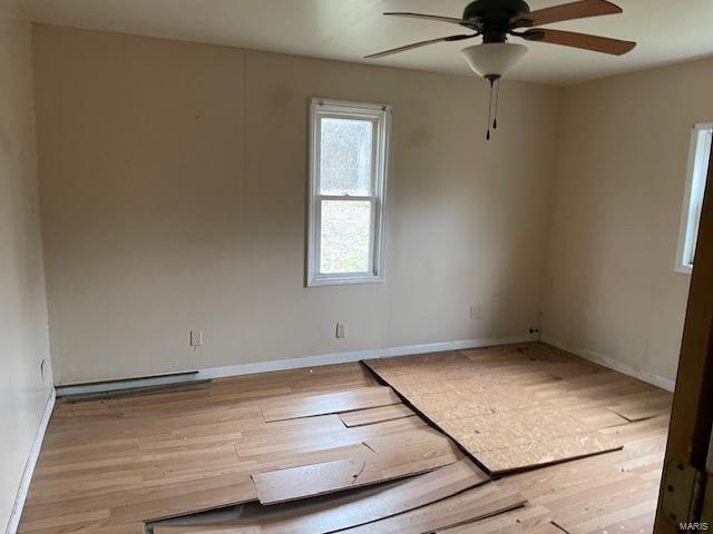 unfurnished room featuring light hardwood / wood-style flooring and ceiling fan