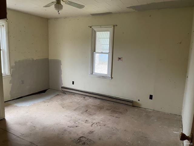 unfurnished room with ceiling fan and a baseboard heating unit