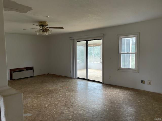 unfurnished living room with ceiling fan