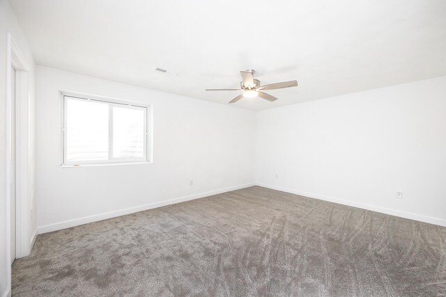 spare room featuring carpet flooring and ceiling fan