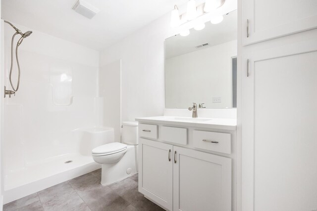 bathroom with a shower, vanity, and toilet