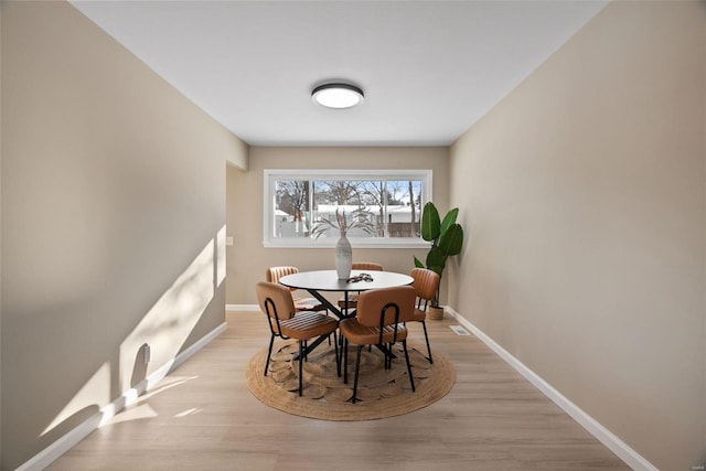 dining space with light hardwood / wood-style flooring