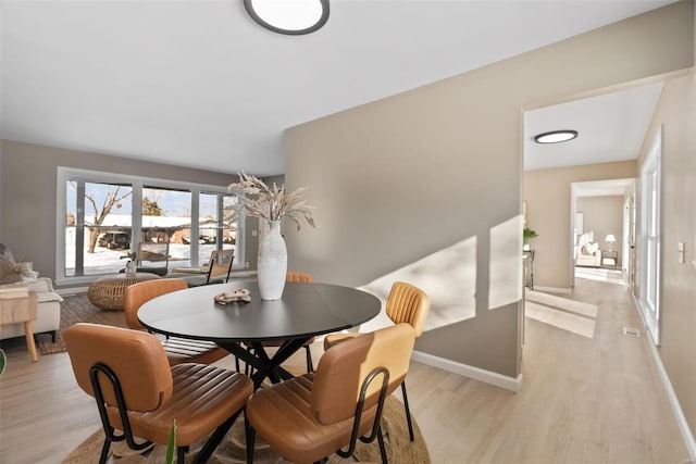 dining area with light hardwood / wood-style floors