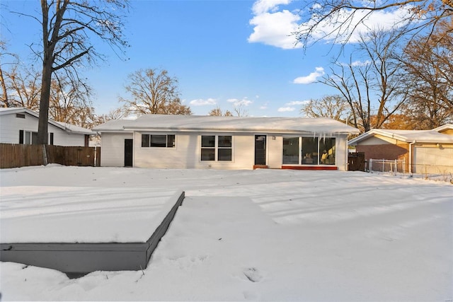 view of snow covered back of property