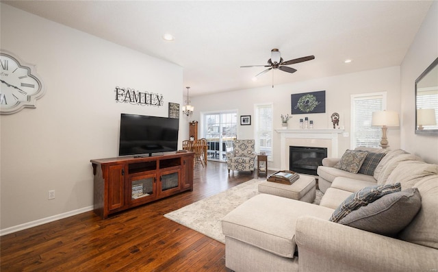 living room with ceiling fan and dark hardwood / wood-style flooring