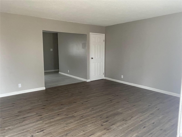 spare room featuring dark hardwood / wood-style floors