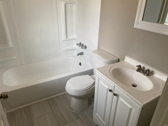 full bathroom featuring washtub / shower combination, toilet, and vanity